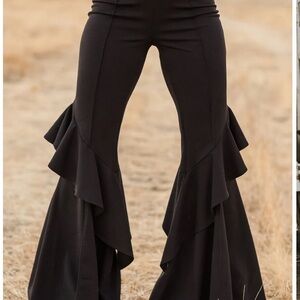 Bell bottomed style suede pants with ruffled flaps along side of legs